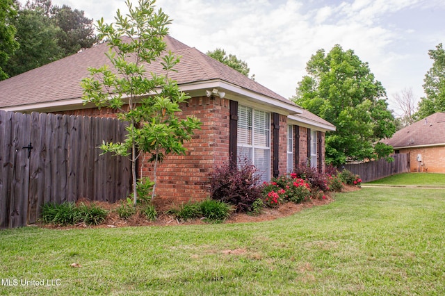 view of property exterior featuring brick siding and roof with shingles