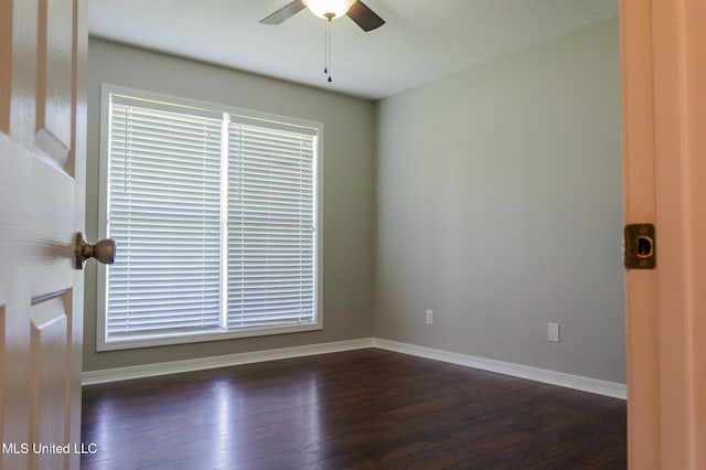 empty room with ceiling fan, hardwood / wood-style floors, and baseboards