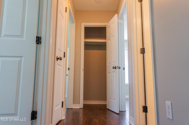 hall with baseboards and dark wood finished floors