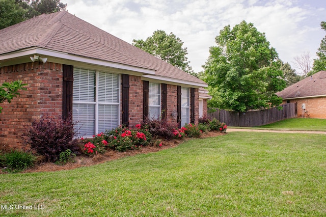 view of side of property with brick siding and roof with shingles