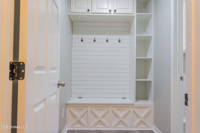 mudroom featuring baseboards and built in features