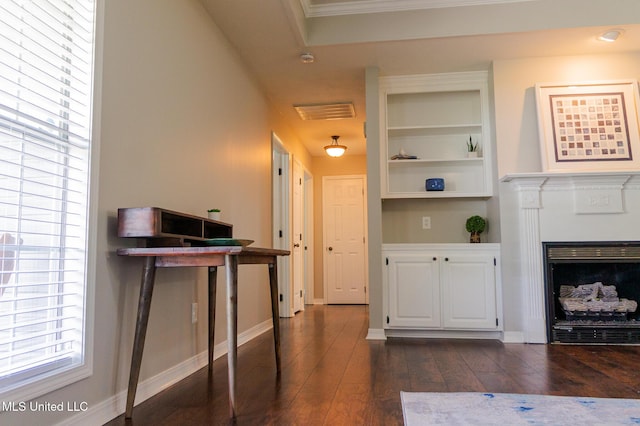 hall featuring dark wood-type flooring, built in features, and baseboards