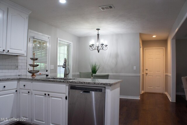 kitchen featuring dishwasher, a sink, dark wood-style flooring, a peninsula, and tasteful backsplash