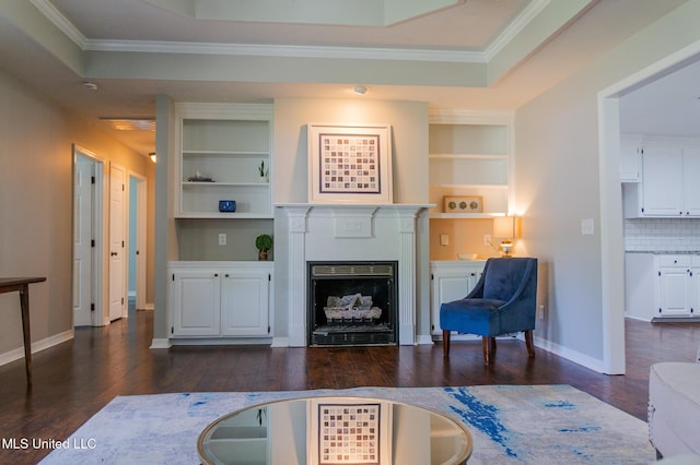 living room featuring dark wood-style flooring, baseboards, a fireplace, crown molding, and built in shelves