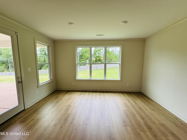 9549 Mcelroy Farms Dr, Olive Branch, MS 38654 - empty room featuring light wood-type flooring, plenty of natural light, baseboards, and crown molding
