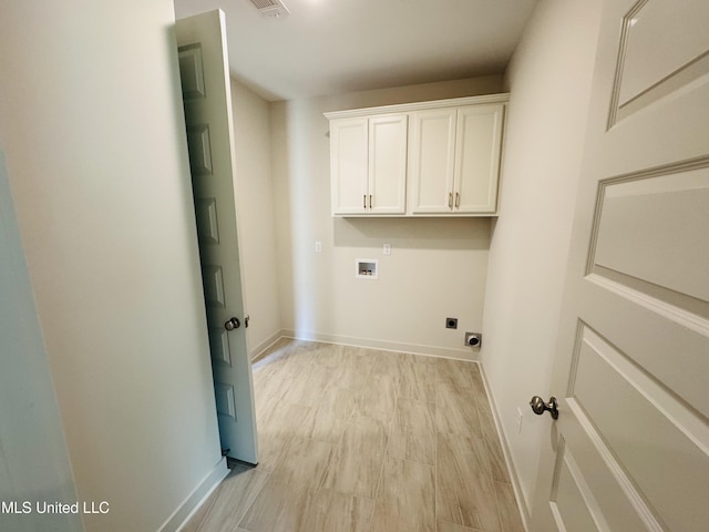 9549 Mcelroy Farms Dr, Olive Branch, MS 38654 - washroom featuring hookup for a washing machine, hookup for an electric dryer, baseboards, cabinet space, and light wood-type flooring