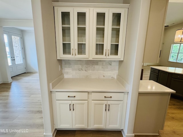 9549 Mcelroy Farms Dr, Olive Branch, MS 38654 - bar featuring wood finished floors, decorative backsplash, and baseboards