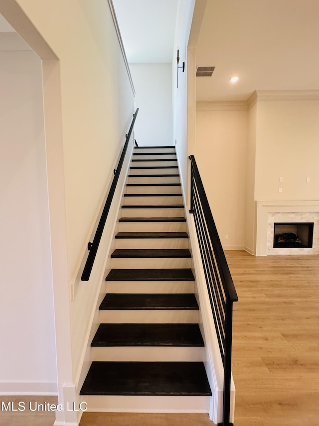 9549 Mcelroy Farms Dr, Olive Branch, MS 38654 - stairway featuring wood finished floors, recessed lighting, a fireplace, and baseboards