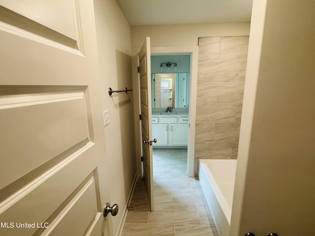 9549 Mcelroy Farms Dr, Olive Branch, MS 38654 - full bathroom with vanity, a bathtub, and marble finish floors