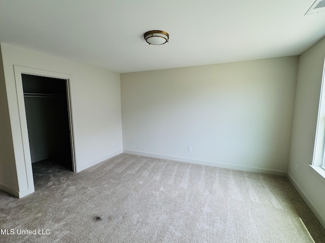 9549 Mcelroy Farms Dr, Olive Branch, MS 38654 - unfurnished bedroom with carpet flooring, baseboards, a walk in closet, and a closet