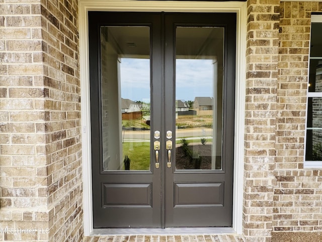 9549 Mcelroy Farms Dr, Olive Branch, MS 38654 - view of exterior entry with french doors and brick siding