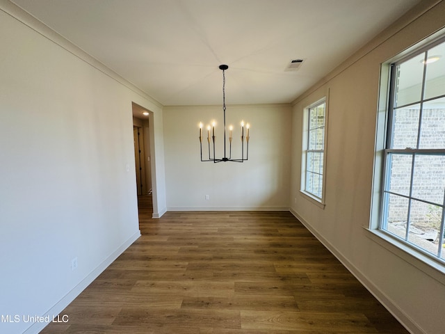 9549 Mcelroy Farms Dr, Olive Branch, MS 38654 - unfurnished dining area with a chandelier, baseboards, dark wood-type flooring, and ornamental molding