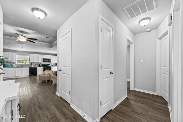 13400 Willow Oak Cir, Gulfport, MS 39503 - corridor with dark wood-type flooring, baseboards, and a sink