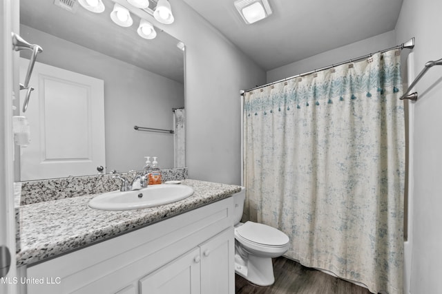13400 Willow Oak Cir, Gulfport, MS 39503 - bathroom with vanity, toilet, and wood finished floors