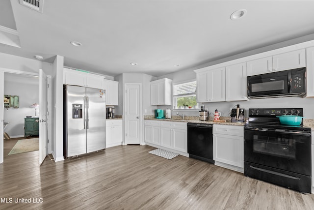 13400 Willow Oak Cir, Gulfport, MS 39503 - kitchen featuring black appliances, white cabinets, light wood-style floors, light stone counters, and recessed lighting