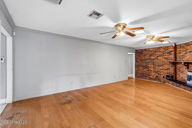 1320 Sally Dr, Picayune, MS 39466 - unfurnished living room with a ceiling fan, hardwood / wood-style floors, a fireplace, crown molding, and baseboards