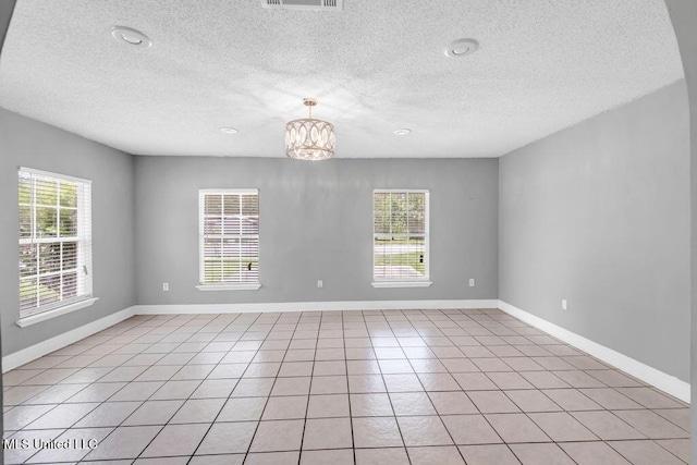 1320 Sally Dr, Picayune, MS 39466 - spare room with plenty of natural light, a textured ceiling, a chandelier, and baseboards