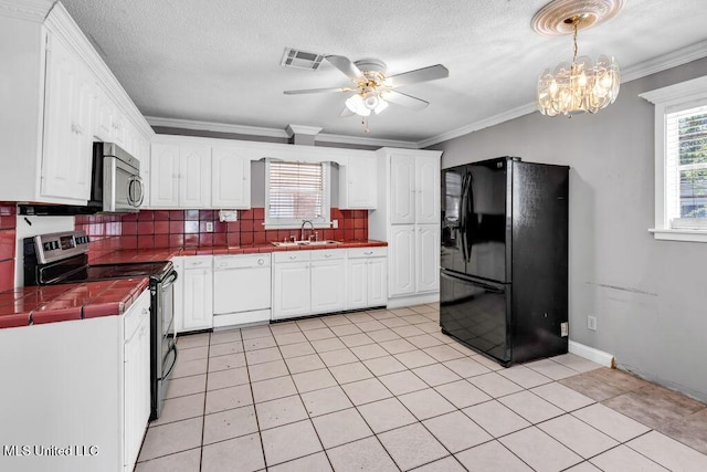 1320 Sally Dr, Picayune, MS 39466 - kitchen featuring stainless steel appliances, tile countertops, a sink, tasteful backsplash, and ceiling fan