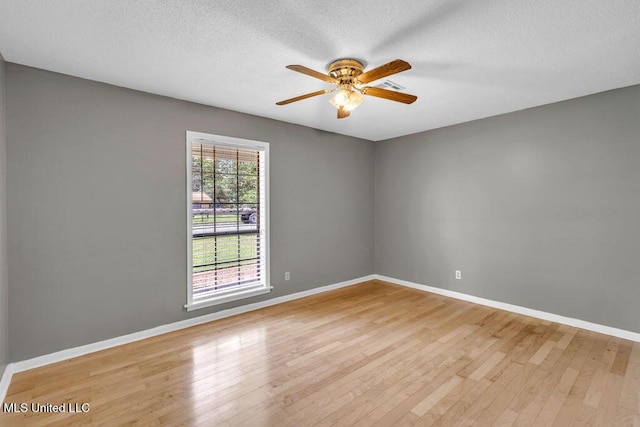 1320 Sally Dr, Picayune, MS 39466 - empty room featuring light wood finished floors, a ceiling fan, baseboards, and a textured ceiling