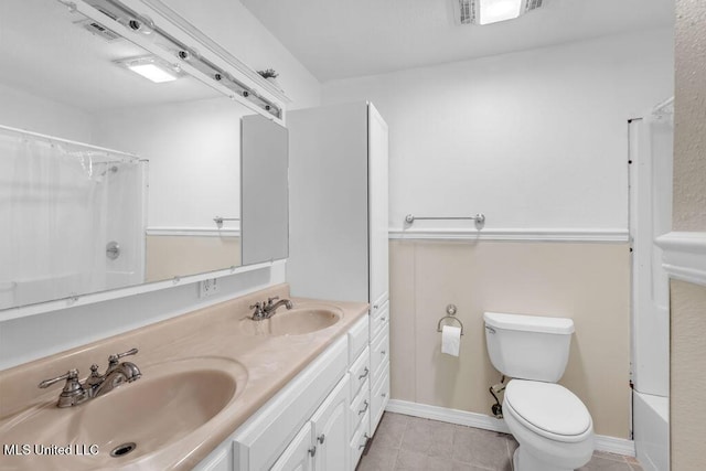 1320 Sally Dr, Picayune, MS 39466 - full bathroom featuring tile patterned flooring, toilet, a shower with shower curtain, and double vanity