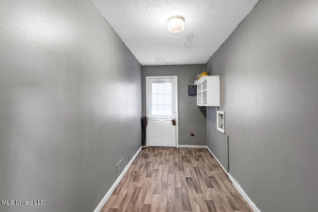 1320 Sally Dr, Picayune, MS 39466 - laundry room featuring wood finished floors, a textured ceiling, hookup for a washing machine, and baseboards