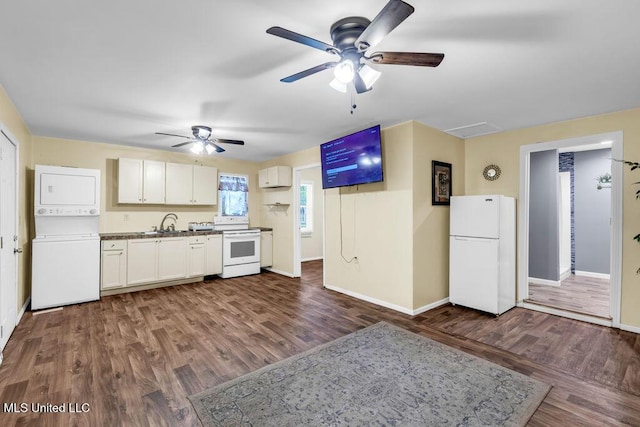 1320 Sally Dr, Picayune, MS 39466 - kitchen with white appliances, stacked washer / dryer, ceiling fan, baseboards, and dark wood-style flooring