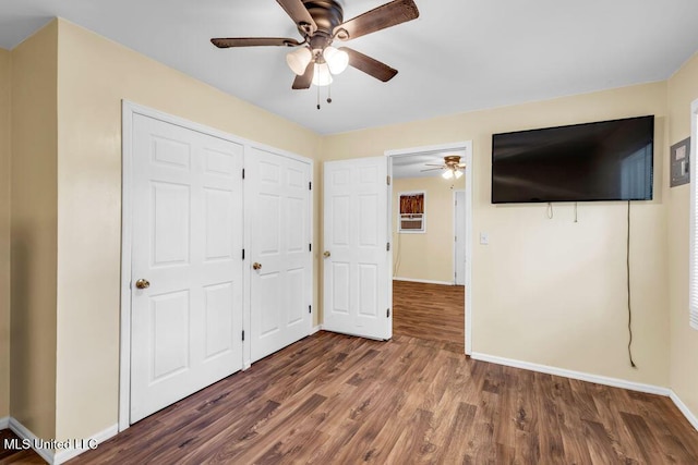 1320 Sally Dr, Picayune, MS 39466 - unfurnished bedroom with wood finished floors, baseboards, a closet, and a ceiling fan