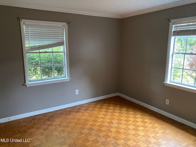 spare room with crown molding and light parquet flooring