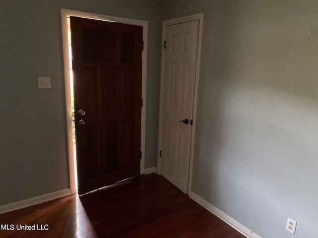 hallway with dark hardwood / wood-style floors