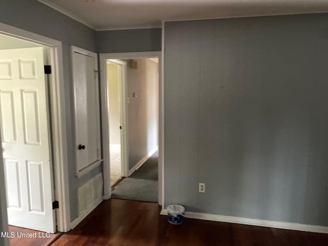 hallway featuring crown molding and dark wood-type flooring