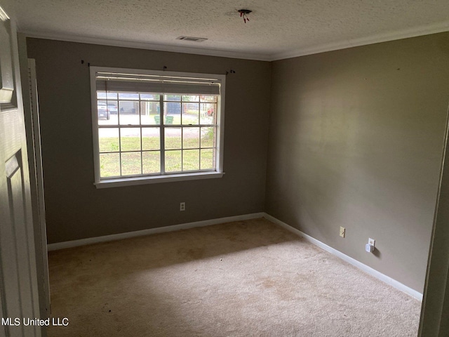 empty room featuring crown molding, a textured ceiling, and light colored carpet