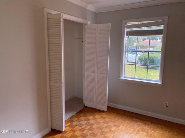 unfurnished bedroom with a closet and light parquet floors