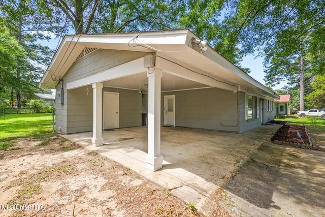 3217 E Lisa Dr, Pearl, MS 39208 - view of property exterior with an attached carport, driveway, and a yard