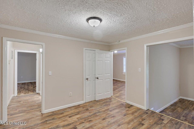 unfurnished bedroom featuring a closet, ornamental molding, a textured ceiling, and dark hardwood / wood-style flooring