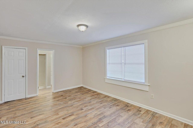 unfurnished room featuring light hardwood / wood-style flooring, a textured ceiling, and crown molding