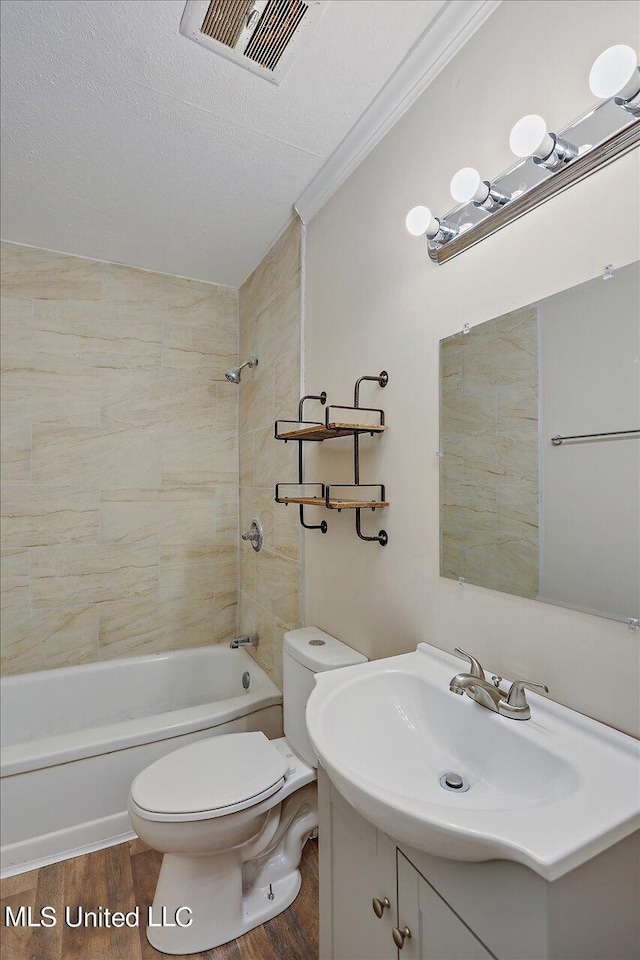 full bathroom featuring vanity, toilet, tiled shower / bath combo, and wood-type flooring