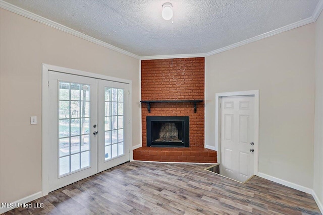 unfurnished living room with french doors, hardwood / wood-style floors, a textured ceiling, and a fireplace