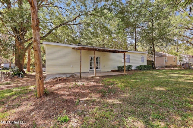 back of house featuring a patio, french doors, and a yard