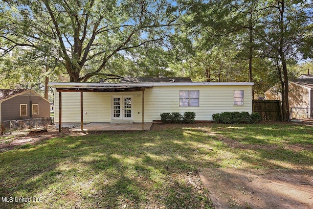 back of house featuring a patio area, french doors, and a yard