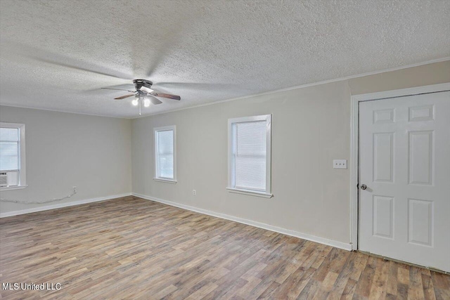 spare room with ceiling fan, crown molding, a textured ceiling, and light wood-type flooring