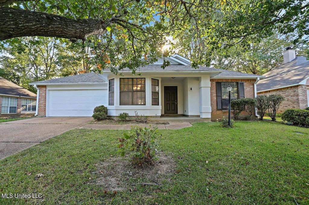 ranch-style home with a front lawn and a garage