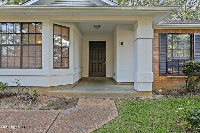 property entrance with brick siding