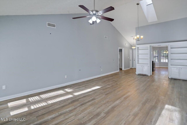unfurnished living room featuring ceiling fan with notable chandelier, high vaulted ceiling, visible vents, baseboards, and light wood-style floors
