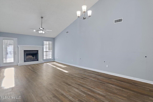 unfurnished living room with visible vents, ceiling fan with notable chandelier, dark wood-type flooring, and high vaulted ceiling