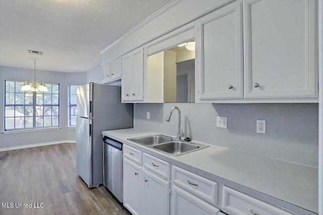kitchen with a sink, white cabinets, stainless steel dishwasher, dark wood-type flooring, and light countertops