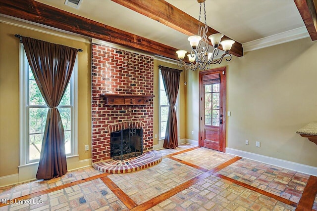 unfurnished living room featuring a fireplace, crown molding, and a chandelier