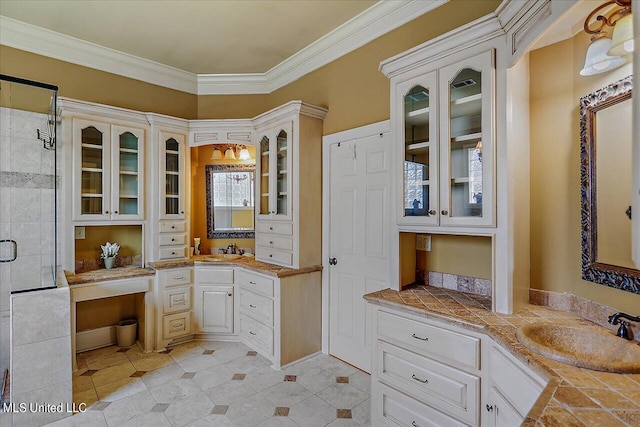 bathroom with an enclosed shower, vanity, and crown molding