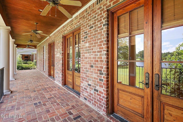 view of exterior entry featuring ceiling fan and french doors