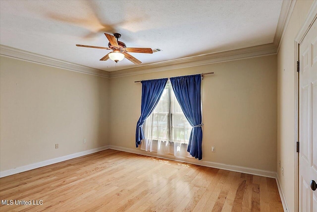 empty room featuring a textured ceiling, ceiling fan, ornamental molding, and wood-type flooring