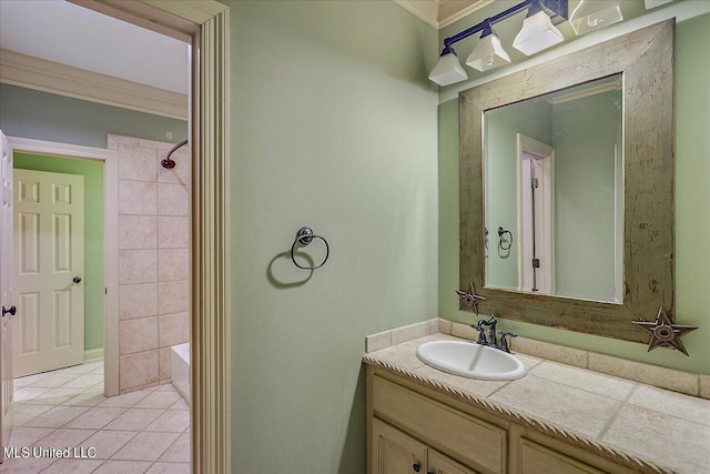 bathroom with bathtub / shower combination, vanity, ornamental molding, and tile patterned flooring